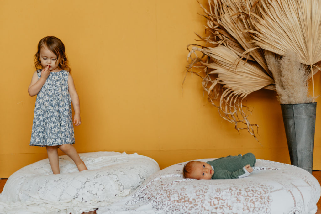 lifestyle newborn session with baby boy and older sister at the Gray Lab in Corvallis Oregon