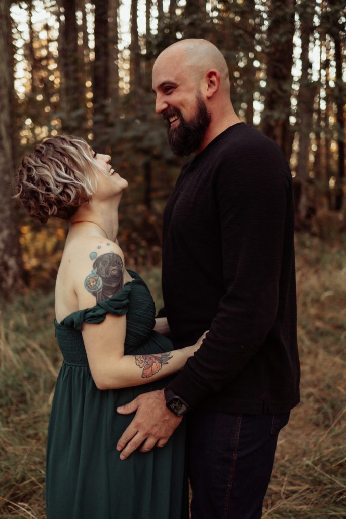 Couple laughing together during maternity session with Eugene Oregon Photographer Lux Marina Photography specializing in maternity, newborn and birth photography