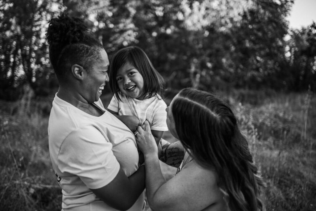 Family session at Mount Pisgah in Eugene Oregon with parents tickling young son laughing