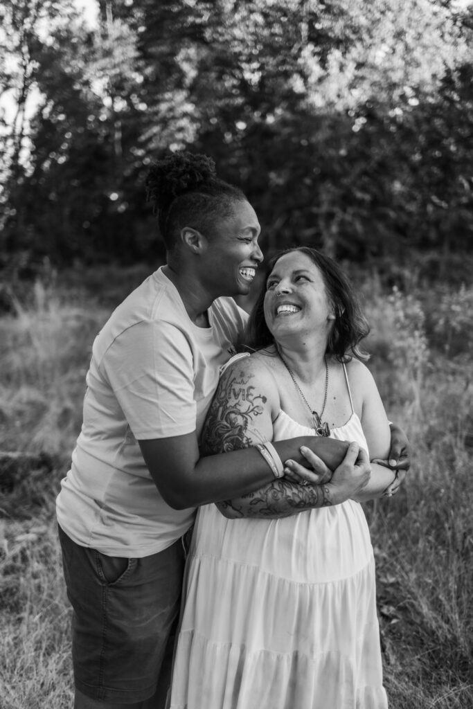 Couple smiling and laughing together during family session with Lux Marina Photography