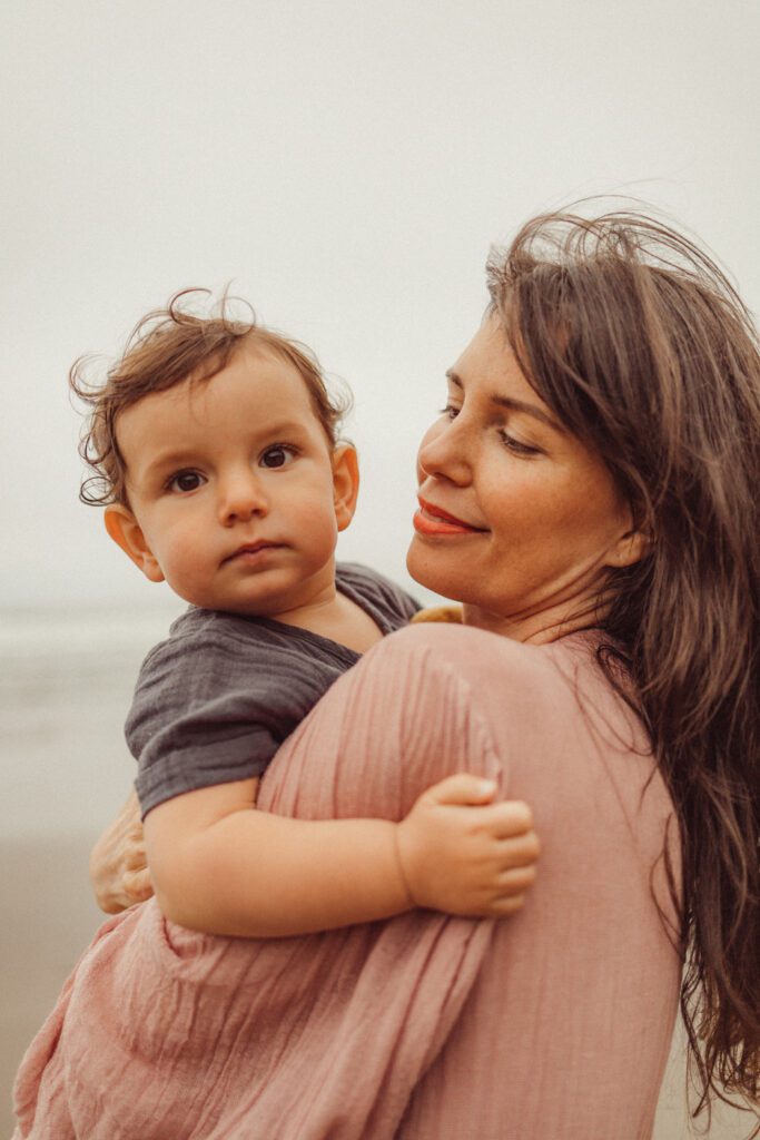 Mother and son cuddling during family photo session at the Oregon Coast 