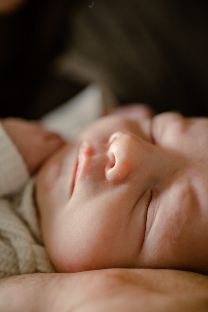 Up close image of newborn baby's sweet little button nose during an in-home newborn session with Lux Marina Photography